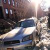 A couple in Brooklyn Heights attempts to dig their car out to make way for snow removal.