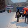 Brooklyn Children enter school in a snowstorm on Thursday, February 13, 2014.