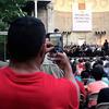 An audience member snaps a photo of The Knights at the Naumburg Bandshell.