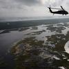  A Louisiana National Guard blackhawk flies over marshland on April 19, 2011 in route to Middle Ground in southern Louisiana. 