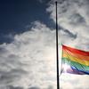 A pride flag stands a half mast during a memorial service in San Diego, California on June 12, 2016, for the victims of the Orlando Nightclub shooting.