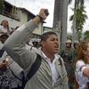 People shout slogans as they protest against the government of Venezuelan President Nicolás Maduro in front of riot policemen outside the Cuban embassy in Caracas on February 25, 2014