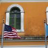 An American flag and Puerto Rican flag fly next to each other in Old San Juan. 