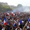 People take the streets around the Arc de Triomphe to celebrate France's World Cup victory over Croatia, in Paris, France, Sunday, July 15, 2018. France won the final 4-2.