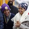 In this Tuesday, Nov. 29, 2016 file photo, Ilhan Omar, center, applauds during a rally at the Minneapolis-St. Paul International Airport in Minneapolis.