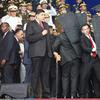 In this photo released by China's Xinhua News Agency, security personnel surround Venezuela's President Nicolas Maduro during an incident as he was giving a speech in Caracas, Venezuela, Saturday