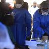 Healthcare workers from the World Health Organization prepare to give an Ebola vaccination to a front line aid worker in Beni Democratic Republic of Congo, Friday, Aug 10, 2018. 