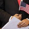 Stallone Laurel Dias, originally of India, and currently serving in the U.S. Army, holds naturalization documents and an American flag during a Naturalization Oath Ceremony, Wednesday, July 18, 2018.
