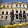 Municipality police guard the National Museum which burned the previous night in Rio de Janeiro, Brazil, Monday, Sept. 3, 2018. 