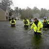 Members of the North Carolina Task Force urban search and rescue team wade through a flooded neighborhood looking for residents who stayed behind as Florence continues to dump heavy rain in Fayettevil