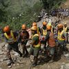 Rescuers carry a body recovered from a landslide caused by Typhoon Mangkhut in Itogon, Benguet province, northern Philippines on Monday, Sept. 17, 2018.