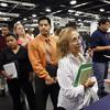 In this June 13, 2012 file photo, Maria Wilt, center, talks to a recruiter at a job fair expo in Anaheim, Calif. 