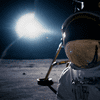 image from film 'first man' of an astronaut on the moon with the lunar module behind him and the reflection of what's in front of him being reflected on his visor