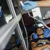 A Central American migrant who attended the annual Migrants Stations of the Cross caravan for migrants' rights receives medical attention from Mexican Red Cross paramedics 