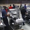 Workers load ballots into machines at the Broward County Supervisor of Elections office during a recount on Sunday, Nov. 11, 2018, in Lauderhill, Fla. 