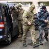 A Ukrainian sailor, right, is escorted by a Russian intelligence agency FSB officer to a court room in Simferopol, Crimea, Tuesday, Nov. 27, 2018. 
