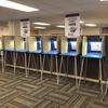 In this Sept. 20, 2018 photo, voting booths stand ready in downtown Minneapolis for the opening of early voting in Minnesota