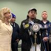EPA employee, Antony Tseng (center), describes the challenges his family is facing during the federal government shutdown at a press conference organized by Rep. Nydia Velázquez (right).