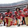 San Francisco 49ers outside linebacker Eli Harold, left, quarterback Colin Kaepernick, center, and safety Eric Reid kneel during the national anthem before an NFL football game