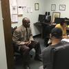 In this May 18, 2017, photo, Nathan Singletary, 67, a social worker for 40 years, listens as Employment Specialist Luz Rivera, 68, interviews program participant Luis Quinones, 66