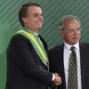 Brazil's new President Jair Bolsonaro shakes hands with his Minister of Economy Paulo Guedes, during a ministerial inauguration ceremony,