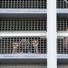 Prisoners call out to protesters and family members gathers outside the Metropolitan Detention Center, a federal prison where prisoners have been without heat, hot water, electricity