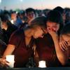Students console each other as they weep during a candlelight vigil for the victims of the Wednesday shooting at Marjory Stoneman Douglas High School, in Parkland, Fla., Thursday, Feb. 15, 2018.