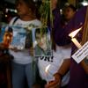 Relatives of victims in President Rodrigo Duterte's so-called war on drugs hold lit candles and display portraits of their loved ones as they gather at a Roman Catholic church
