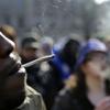 People smoke marijuana cigarettes as a large group gathered near the New Jersey Statehouse to show their support for legalizing marijuana Saturday, March 21, 2015, in Trenton, N.J. 