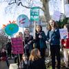 a group of children protesting with signs, some read 'there is no PLANet B' and 'stop these ferocious flames' with a planet on fire