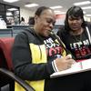 Former felon Yolanda Wilcox, left, fills out a voter registration form as her best friend Gale Buswell looks on at the Supervisor of Elections office Tuesday, Jan. 8, 2019, in Orlando, Fla. 