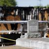 Graves from a cemetery are seen behind the burnt ruins of the Greater Union Baptist Church, one of three that recently burned down in St. Landry Parish, are seen in Opelousas, La., Wednesday, April 10