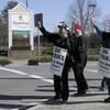 Union workers picket outside a Stop & Shop supermarket, Thursday, April 11, 2019, in Norwell, Mass., after workers walked off the job in Massachusetts, Rhode Island and Connecticut