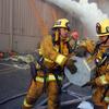 Firefighters help remove film canisters from a burning video vault at Universal Studios in Universal City, Calif. on Sunday, June 1, 2008. 