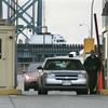 Customs Border Protection officers check vehicles entering the United States from Canada at the Ambassador Bridge in Detroit, Tuesday, April 21, 2009. 
