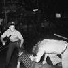  In this Aug. 31, 1970 file photo, a NYPD officer grabs a youth by the hair as another officer clubs a young man during a confrontation in Greenwich Village after a Gay Power march in New York.