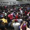 Migrants wait for a turn in line to solve their migratory situation, at an immigration center in Tapachula, Chiapas state, Mexico, Monday, May 27, 2019.
