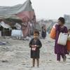 Afghan refugees who fled their homeland due to war and famine, are on their way to collect clean water in slums of Lahore, Pakistan, Wednesday, June 19, 2019.