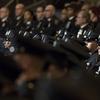 The newest members of the New York City police officers, foreground, and police brass take part in their graduation ceremony, Thursday, March 30, 2017, in New York. 
