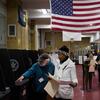 Poll worker Arlen Baden, left, assists a voter, Tuesday, Nov. 6, 2018, in the Brooklyn borough of New York. 