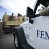 In this Oct. 5, 2017 file photo, Department of Homeland Security personnel deliver supplies to Santa Ana community residents in the aftermath of Hurricane Maria in Guayama, Puerto Rico.