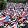 Demonstrators march on Las Americas highway demanding the resignation of governor Ricardo Rossello, in San Juan, Puerto Rico, Monday, July 22, 2019.