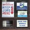 In this Nov. 27, 2018 photo, signs hang from windows at the UAW Local 1112 union hall, in Lordstown, Ohio. 