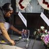 Jamila McNichols, sister of slain mass shooting victim Thomas 'TJ' McNichols, mourns beside a memorial near the scene of the mass shooting Monday, Aug. 5, 2019, in Dayton, Ohio.