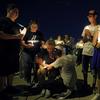 People attend a candlelight vigil for victims of a mass shooting over the weekend at a shopping complex, Monday, Aug. 5, 2019, in El Paso, Texas. 