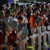 People crowd around a makeshift memorial near the site of a mass shooting over the weekend at a shopping complex, Monday, Aug. 5, 2019, in El Paso, Texas. 