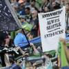 In this July 21, 2019, photo, a sign that reads 'Anti-Facist Always Seattle Anti-Racist' is displayed in the supporters section during an MLS soccer match between the Seattle Sounders and the Portland