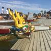 Dragon heads rest on the dock at Meadow Lake waiting for their turn to race.