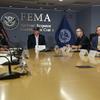 President Donald Trump, left, listens as Kenneth Graham, director of NOAA's National Hurricane Center, on screen, gives an update during a briefing about Hurricane Dorian.
