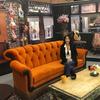 This Sept. 5, 2019 photo shows actress Maggie Wheeler, who played Janice on the NBC sitcom 'Friends,' posing in a replica of the Central Perk set, at the New York City Pop-Up experience in New York.